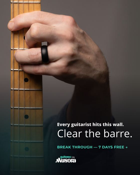 Guitareo static ad: a hand barring the guitar neck